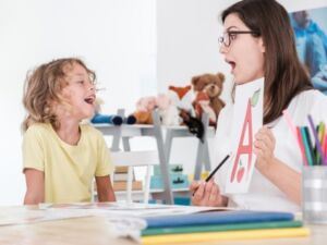 Tutor and child learn a letter A