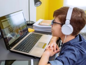 A student boy is in an online tutoring session with the Commonwealth Learning Center