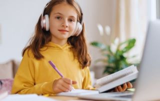A student is near the computer during the virtual tutoring session with the Commonwealth Learning Center