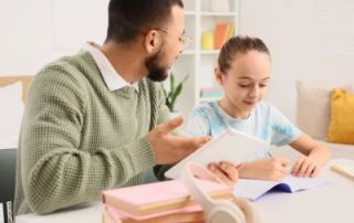Adult helping a child with schoolwork at a table, illustrating individualized learning support for neurodivergent students and children with learning differences or learning disabilities.